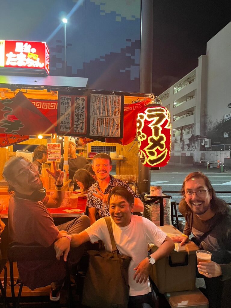 Gente feliz en un puesto de comida callejera en Fukuoka, Japón